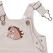 Beige corduroy overalls with a horse applique on a white background