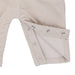 Beige baby romper with button details on a white background