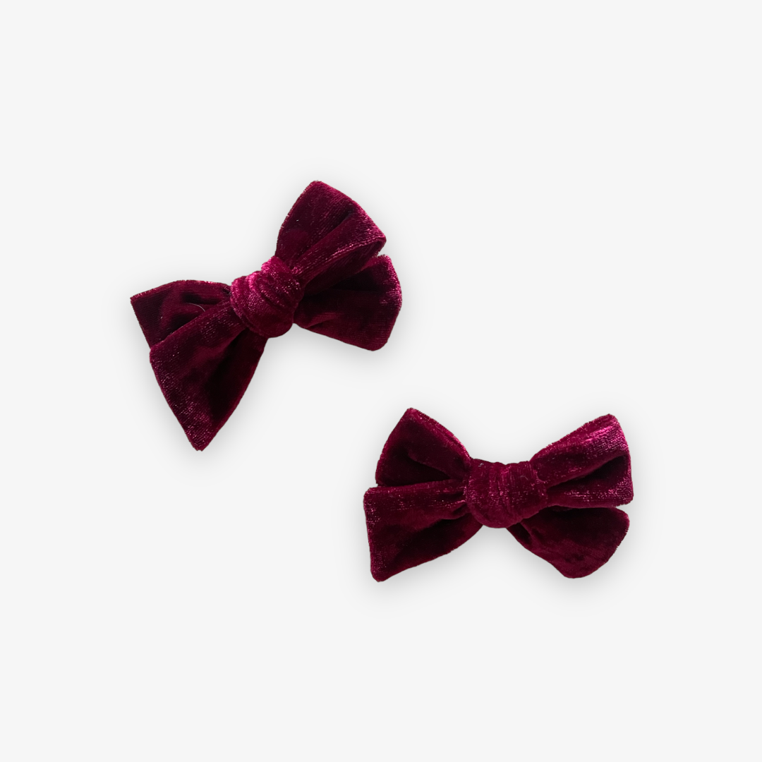 two cranberry colored velvet bow with alligator clips
