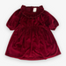 cranberry colored velvet dress with ruffle detail at the neck