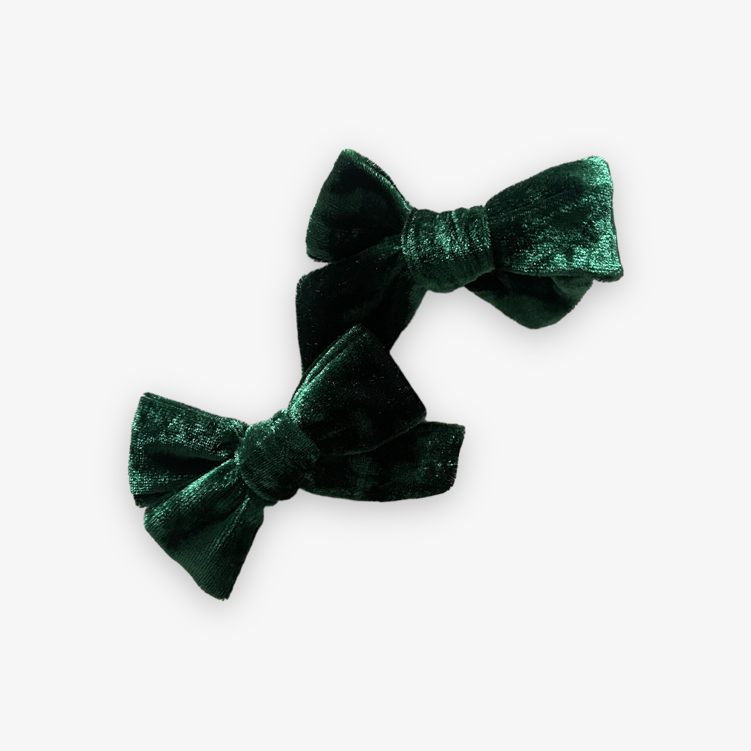 two dark green velvet bows with alligator clips