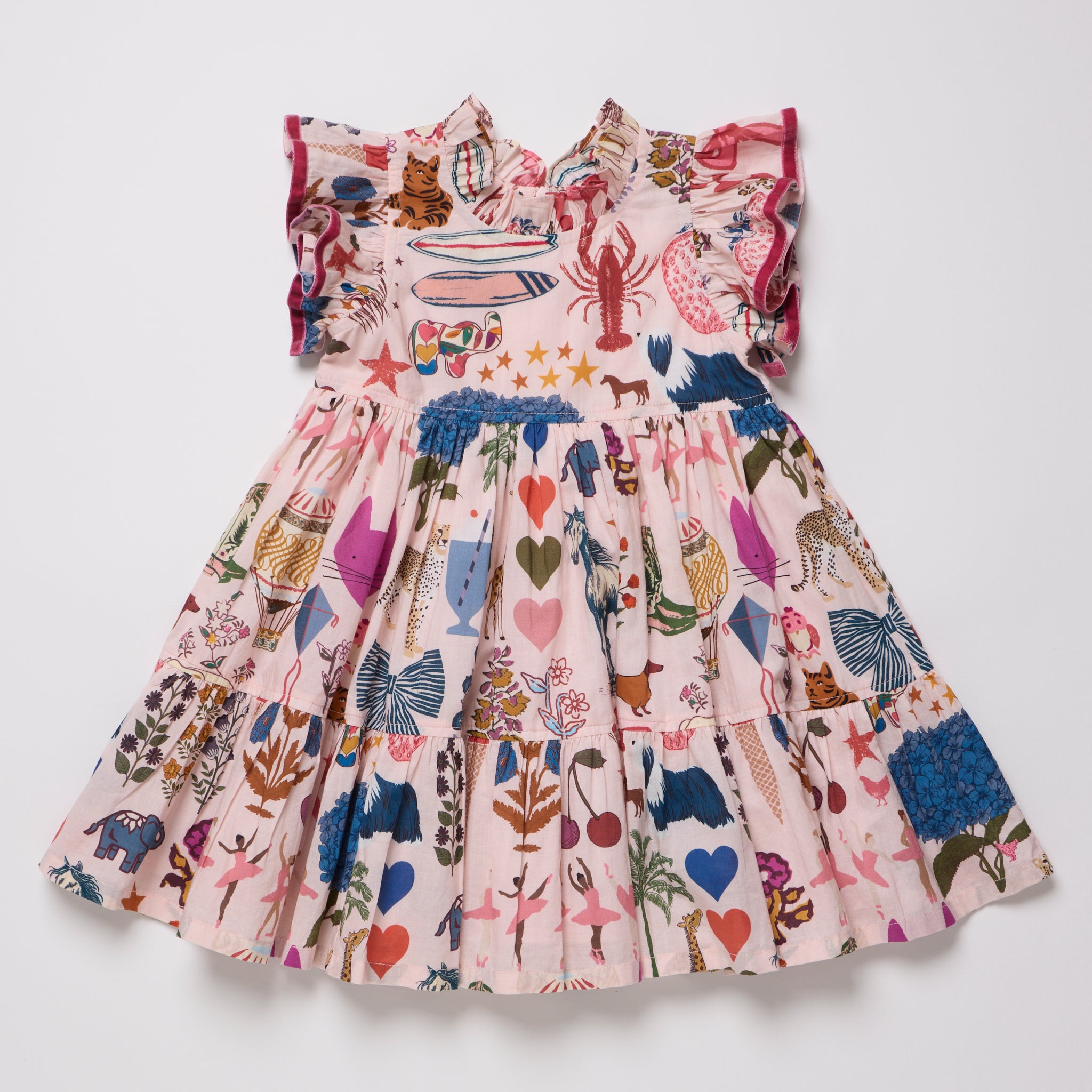 A pink tiered baby dress with ruffled shoulder straps, featuring a whimsical patchwork print of sea creatures, hearts, stars, and botanical motifs in multiple colors, laid flat against a light gray background.