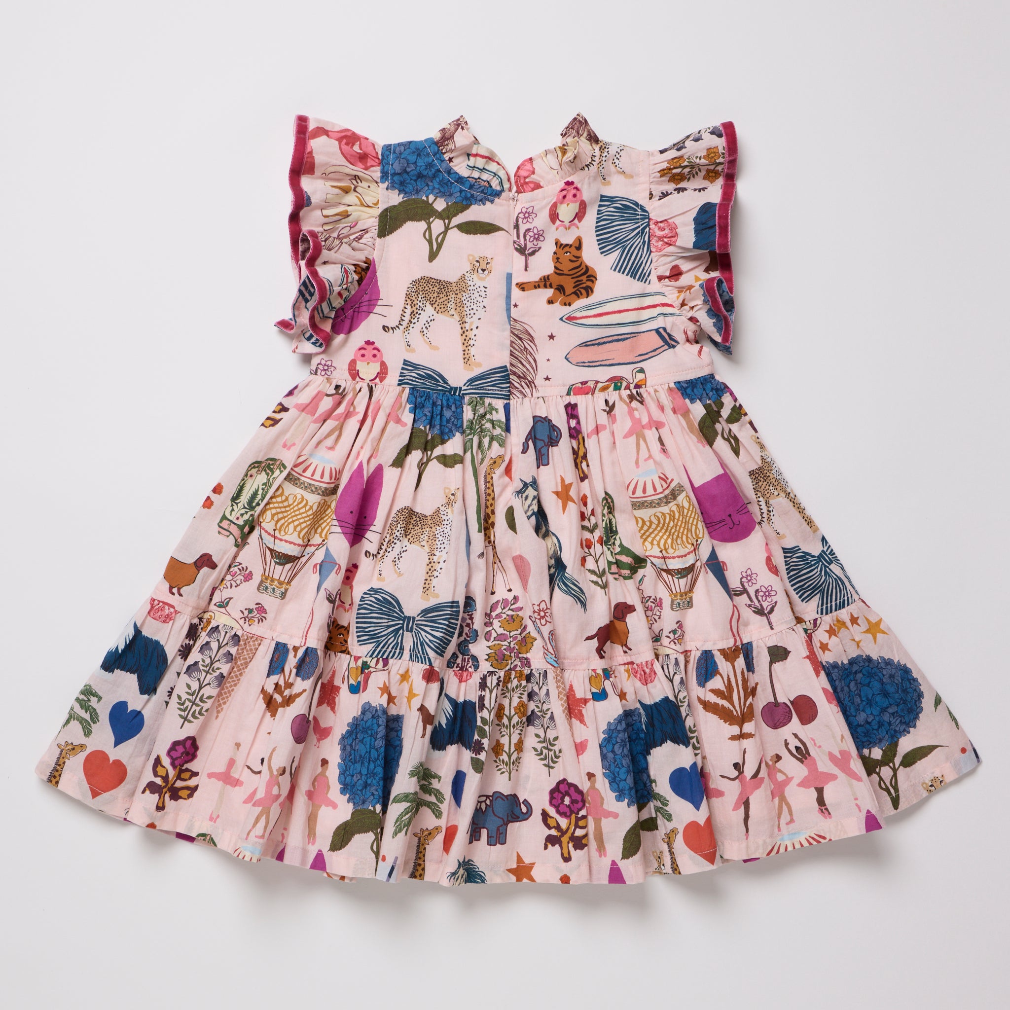 A pink tiered babydoll dress with a whimsical multicolor print of animals, flowers, and butterflies, featuring ruffled cap sleeves and a smocked bodice, laid flat on a light gray background.