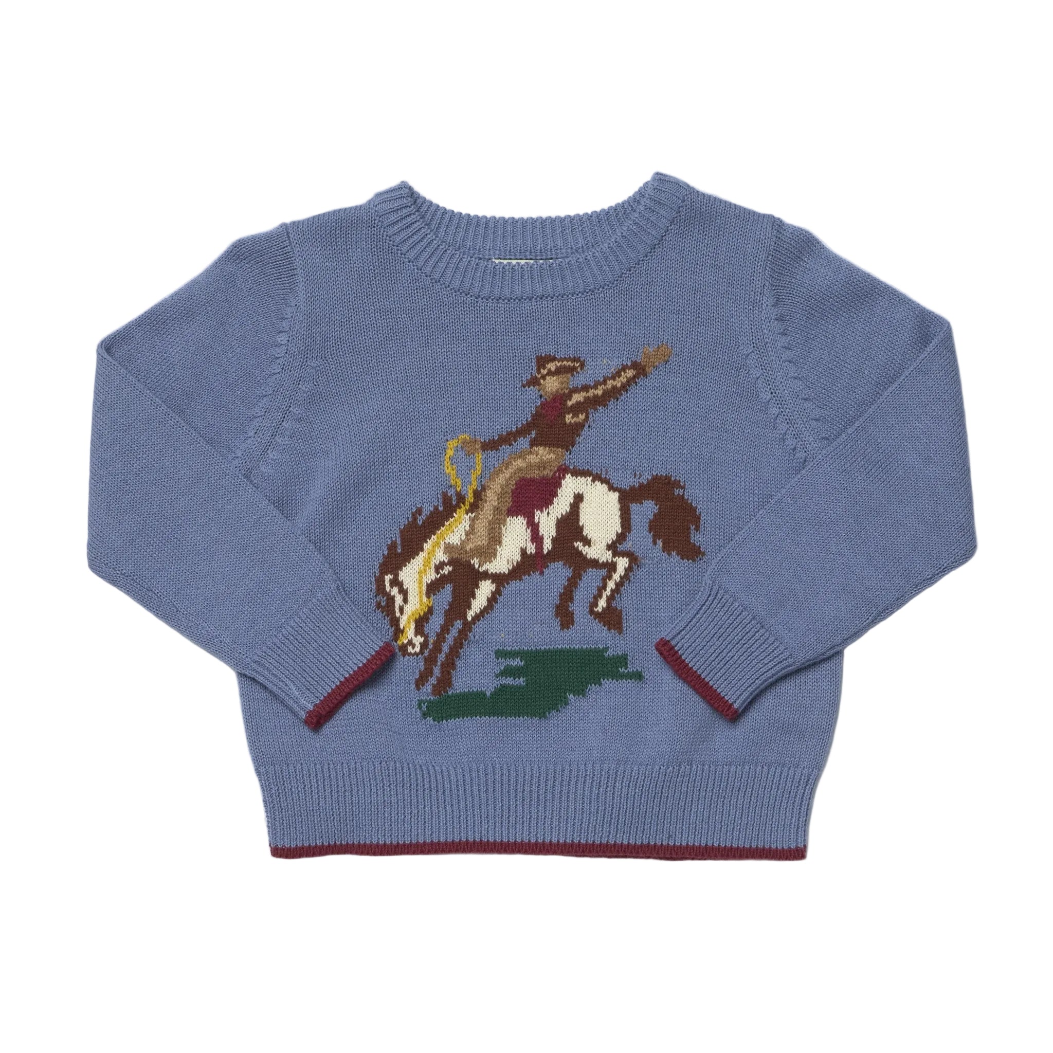 A dusty blue cropped sweatshirt featuring a graphic of a cowboy riding a horse with a lasso, displayed flat against a white background.
