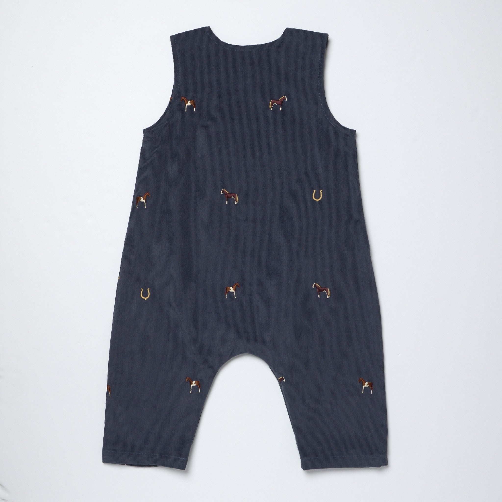 A navy blue sleeveless baby romper with small embroidered horse and horseshoe motifs, laid flat on a light gray background.