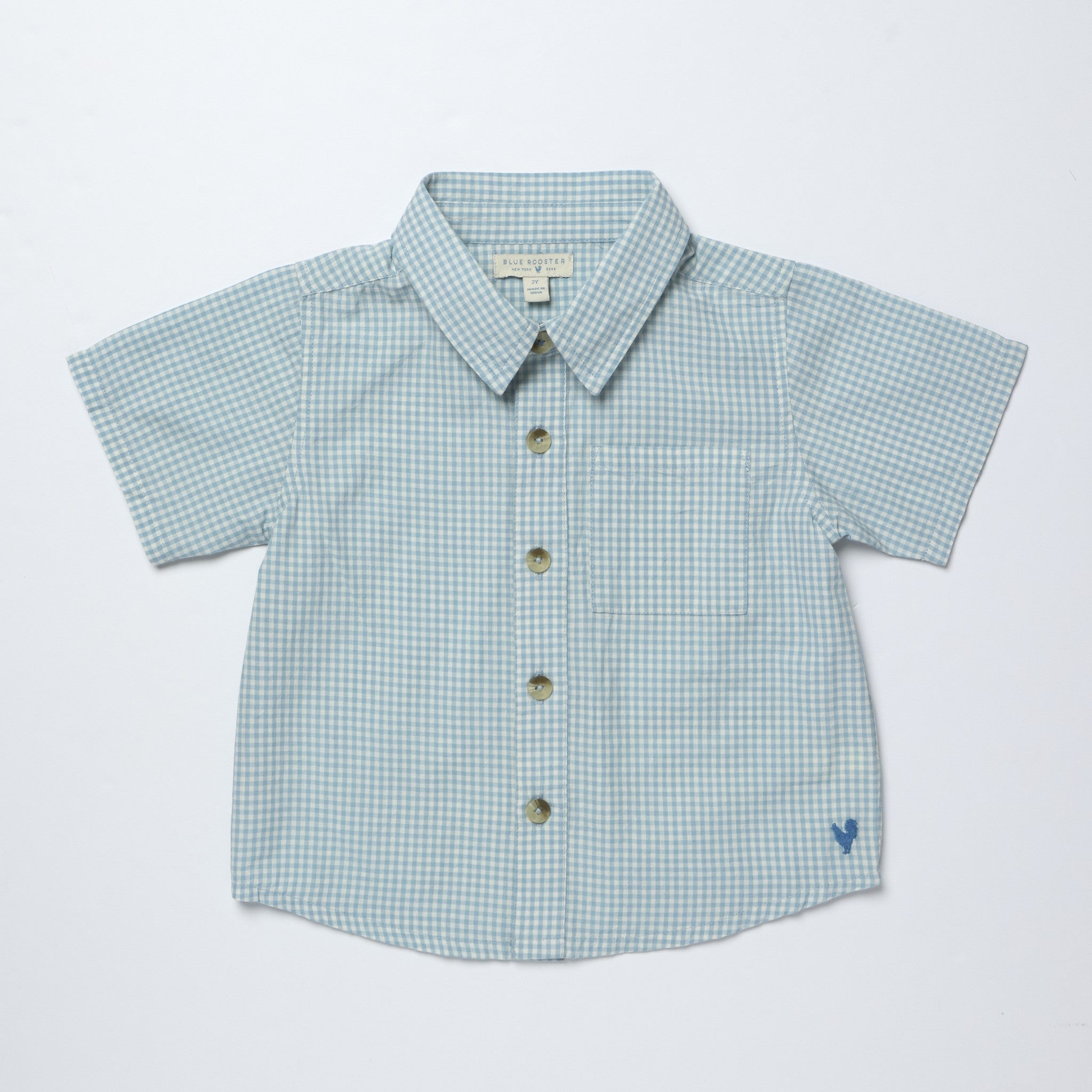 Blue gingham shirt with buttons on a light gray background