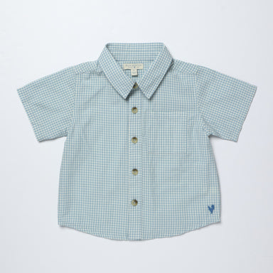 Blue gingham shirt with buttons on a light gray background