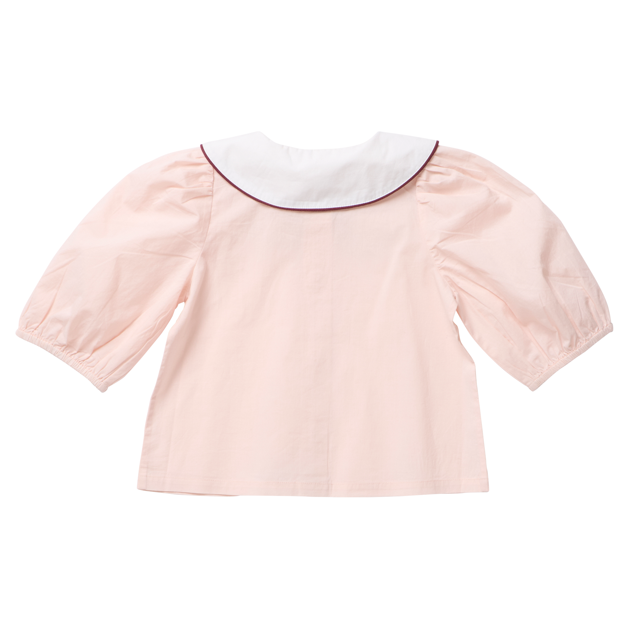 A light pink children's blouse shown from the back, featuring a white Peter Pan collar with a thin dark red piping trim and voluminous elbow-length puff sleeves.