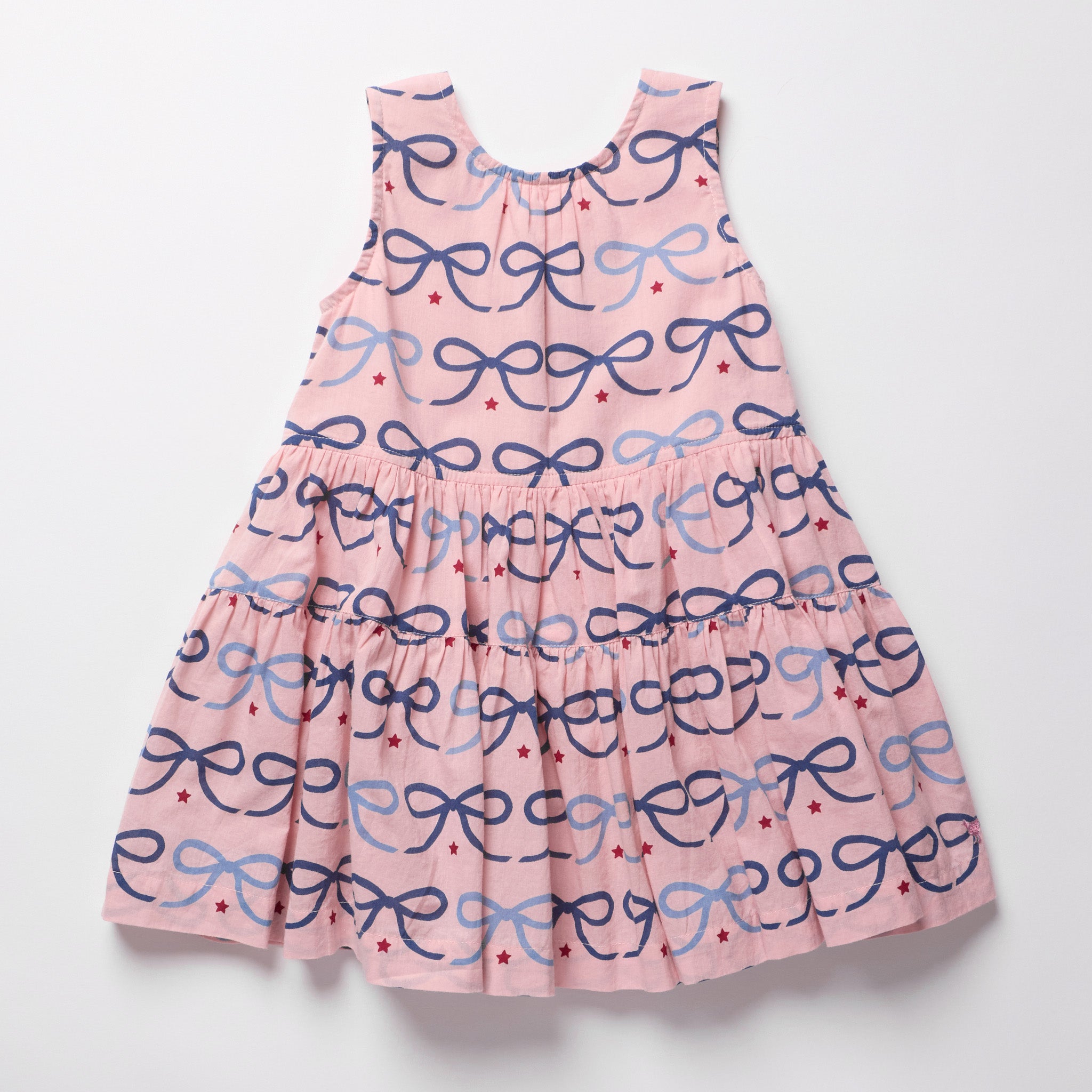 Pink dress with blue bow pattern on a white background