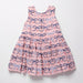 Pink dress with blue bow pattern on a white background