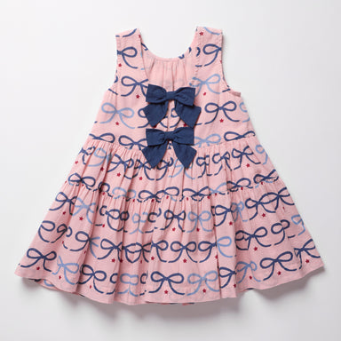 Pink dress with blue bow pattern on a white background