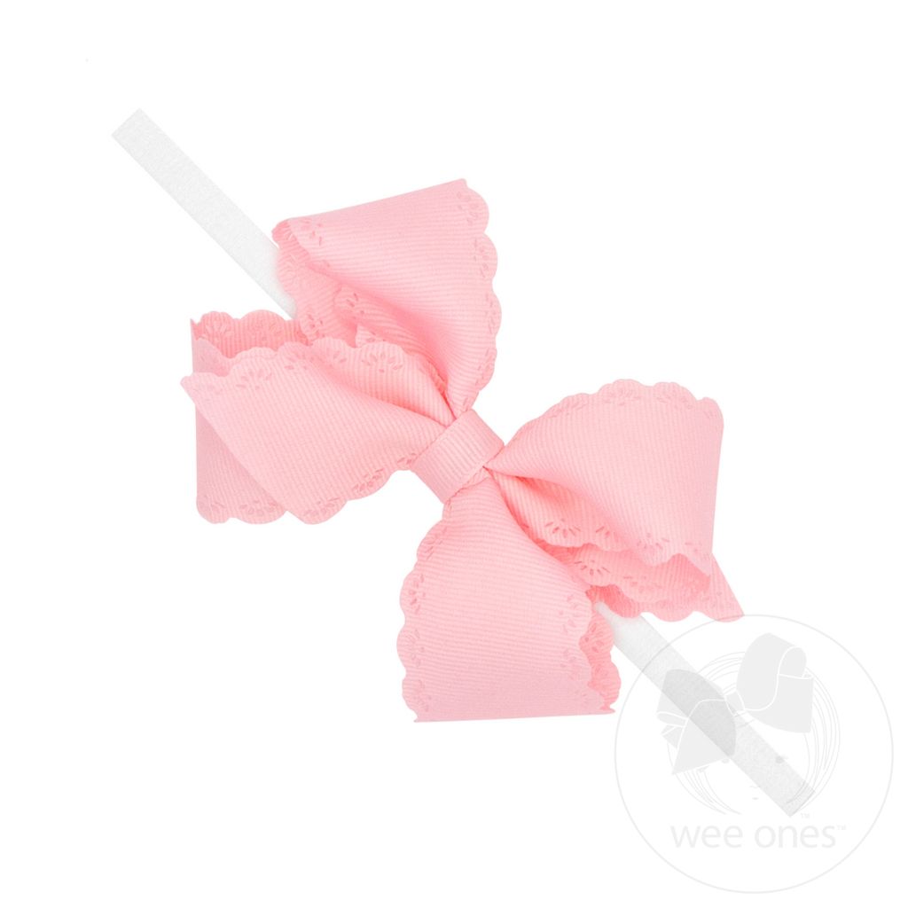 Pink bow headband on a white background