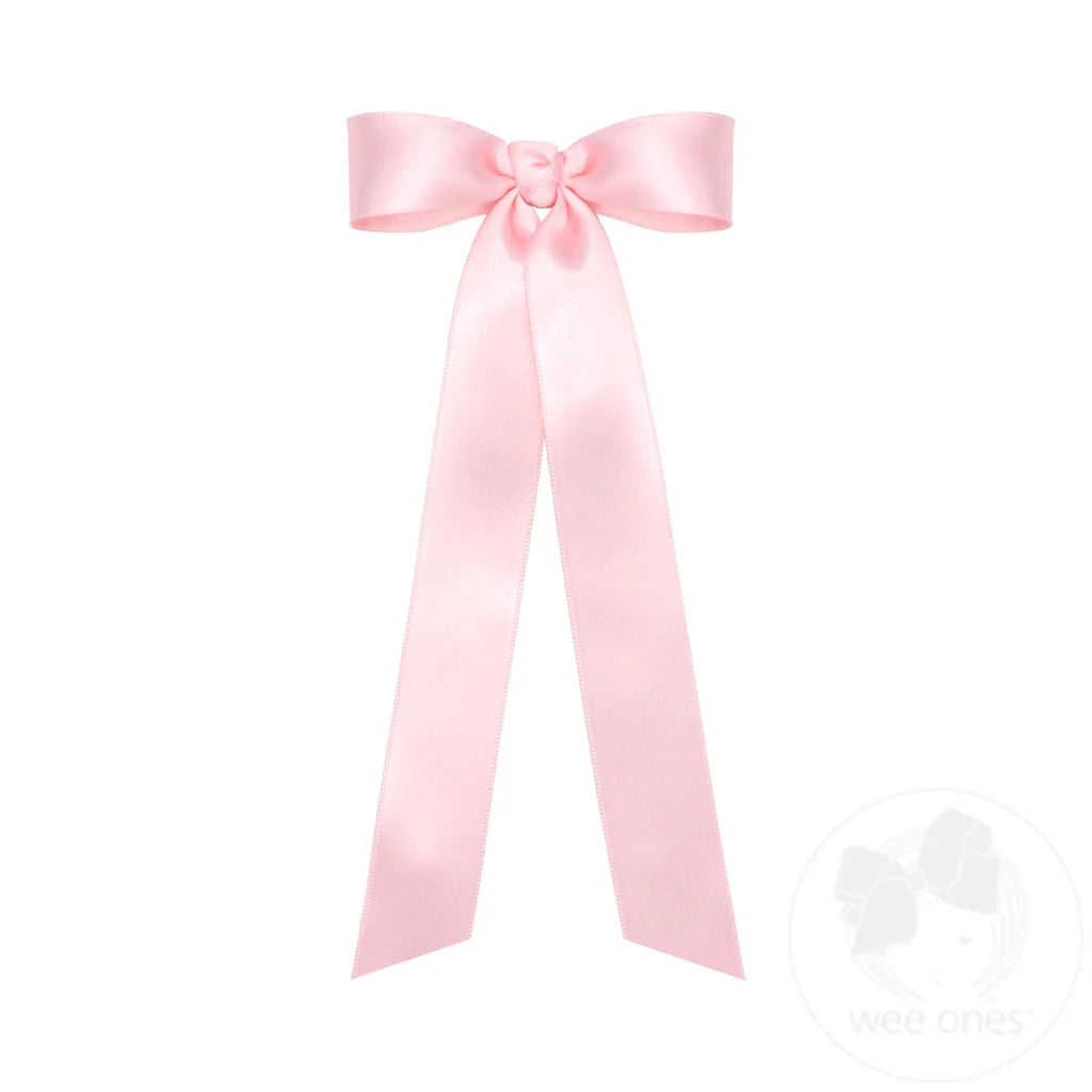 Pink satin bow on a white background