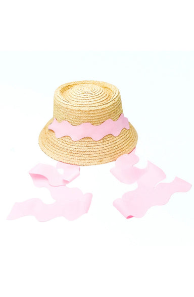 Woven hat with pink ribbon on a white background