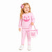 A young girl with blonde hair wearing a pink two-piece pajama set with a jack-o'-lantern graphic, holding a pink gingham pumpkin bucket bag, on a solid white background.