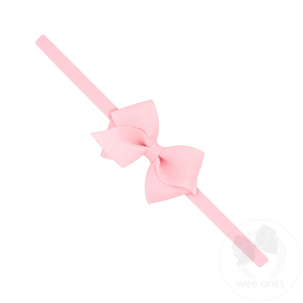 Pink bow headband on a white background