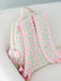 Floral patterned backpack with ruffles on a light background