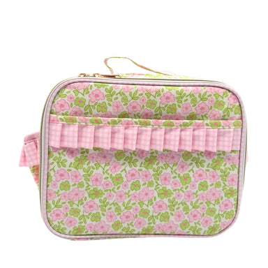 Floral patterned lunchbox with pink ruffle on a pink background