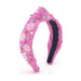 hot pink knotted headband with pink snowflake charms and pink and blue rhinestones and pearls