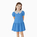 Young girl wearing a blue dress with a patterned collar on a white background