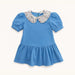 Blue dress with a patterned collar on a white background