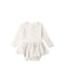 A Pointelle Skirted Bodysuit featuring a peplum skirt, long sleeves, and a delicate bow at the neckline. Designed with snaps at the shoulder and bottom for easy changes.