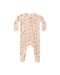 A baby long-sleeve footed sleeper in a light peach-beige color, featuring a delicate all-over print of Halloween candy, with a front zipper closure.