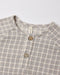 Close-up of a children's long-sleeve henley shirt with a light blue gingham pattern, featuring a button placket with wooden buttons.