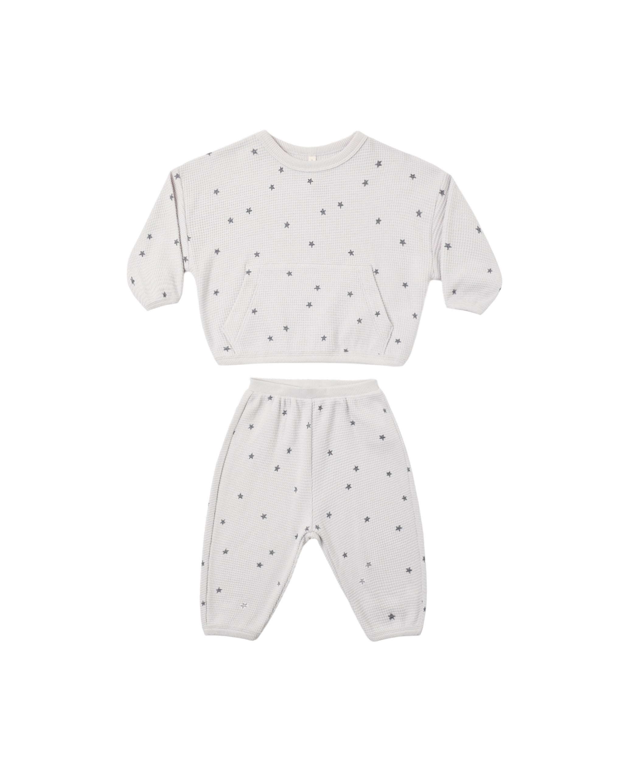 A two-piece set featuring a relaxed long sleeve top with a roomy front pocket and matching pants for easy movement