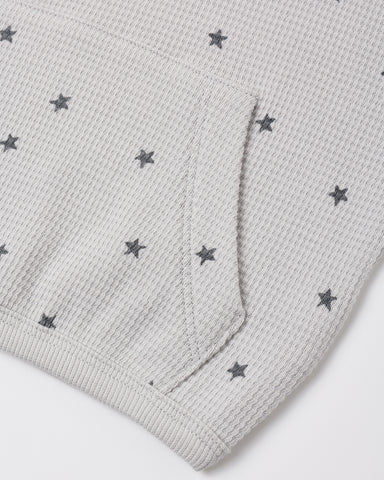 A close up a waffle grey fabric with a star pattern