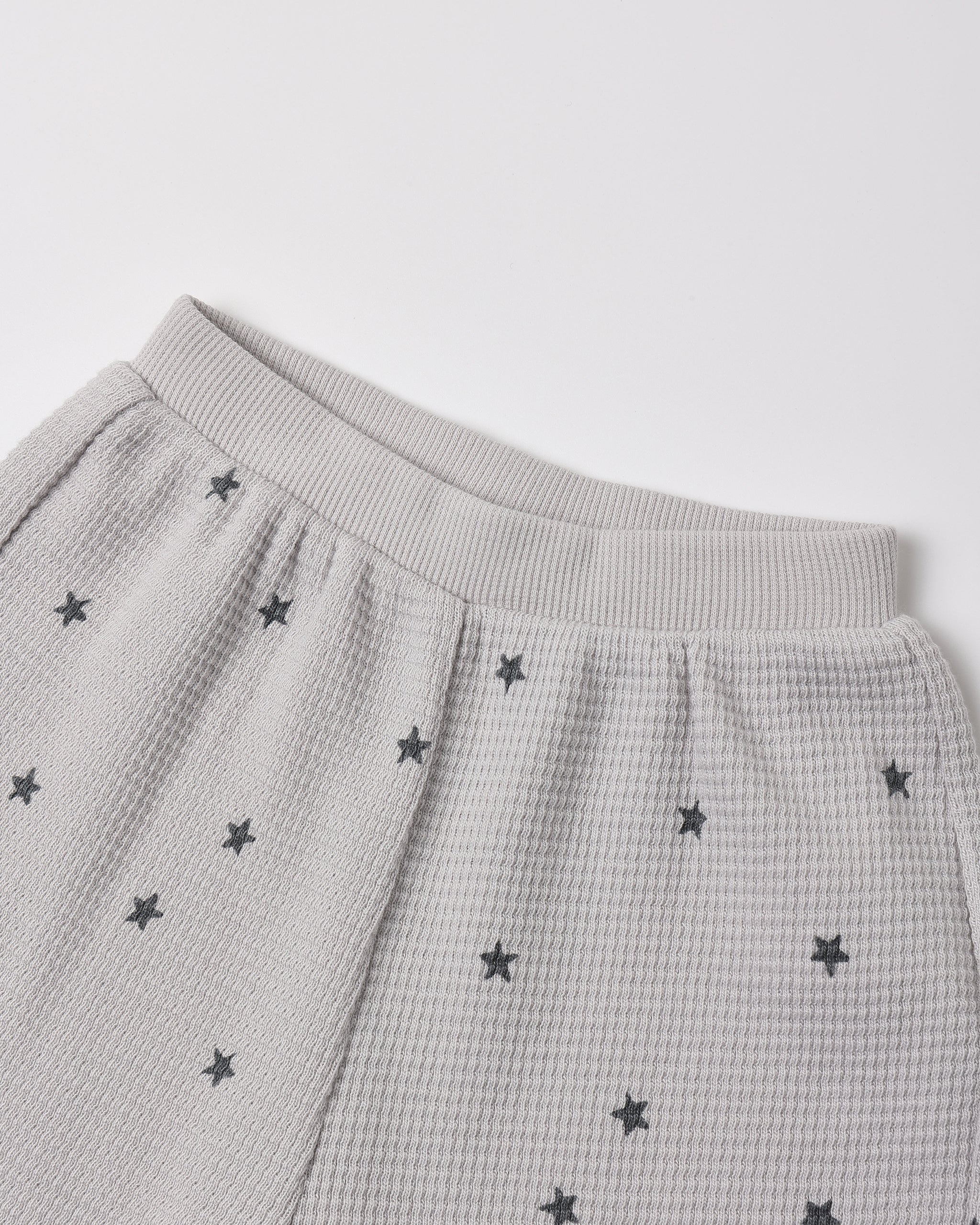 A close up a waffle grey fabric with a star pattern