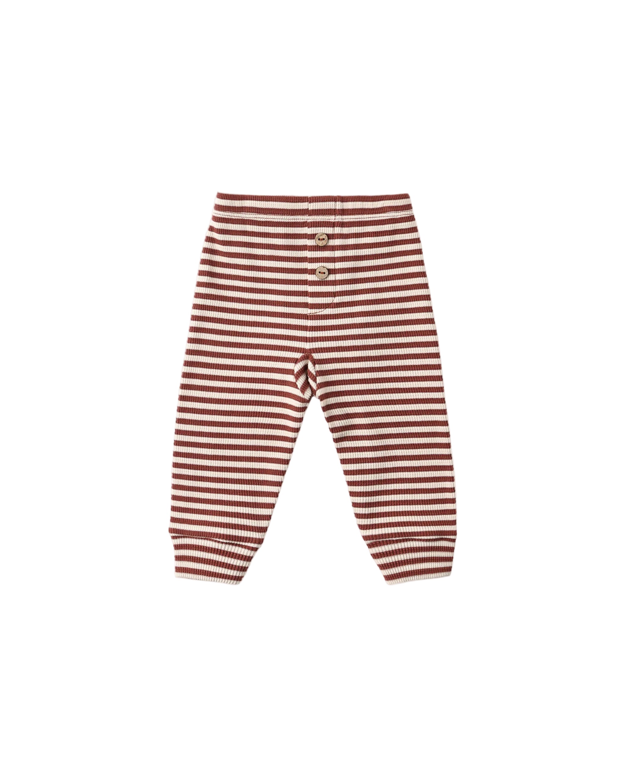 Ribbed leggings with horizontal rust red and cream stripes, featuring a wooden button closure, on a light white  background.