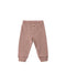 Ribbed leggings with horizontal rust red and cream stripes, featuring a wooden button closure, on a light white  background.