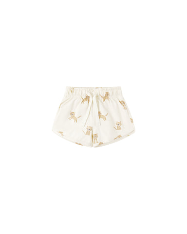 Natural colored shorts with lion pattern on a white background