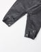 Close up of the overalls showing the snaps on the legs and the fabric.