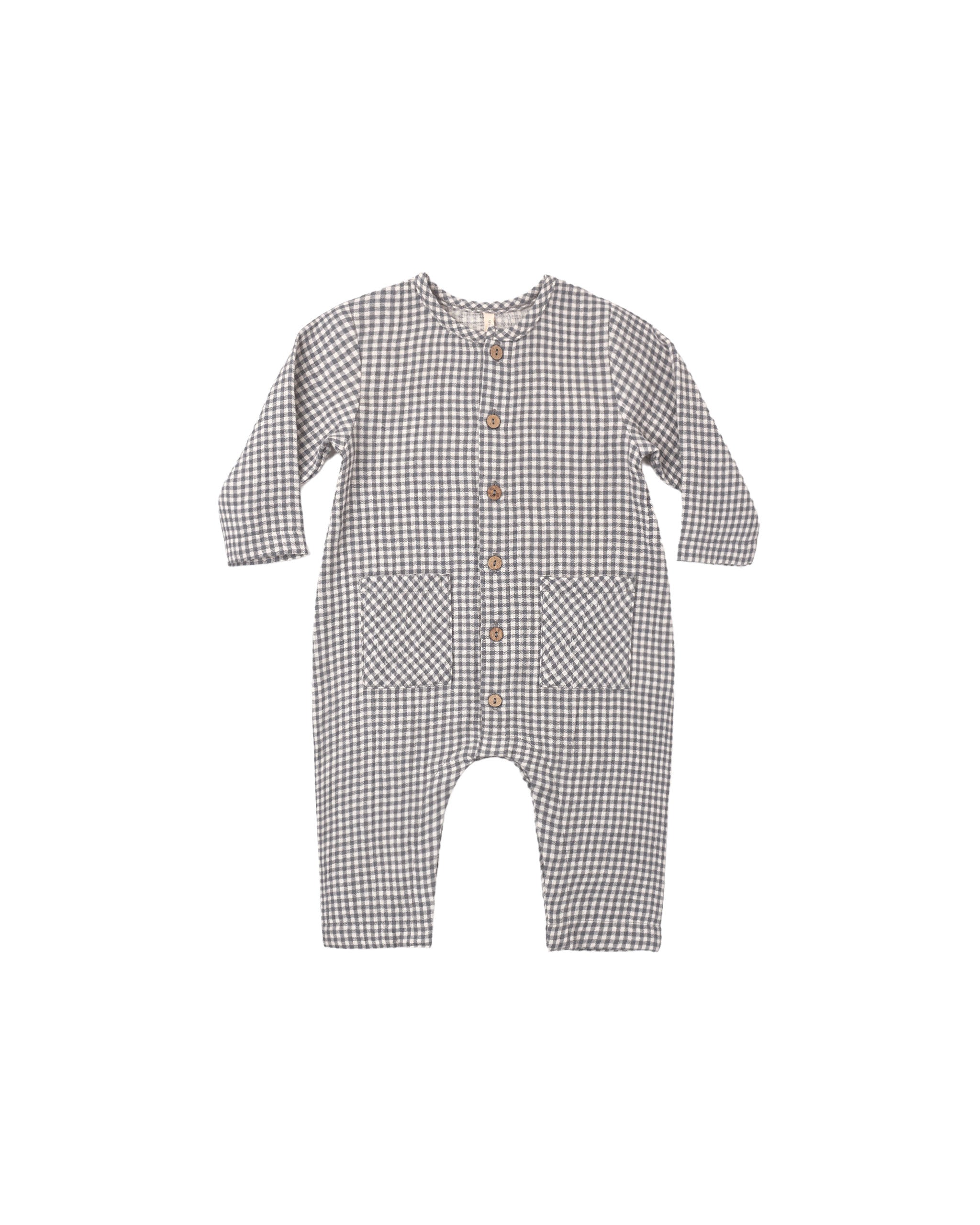 A black gingham jumpsuit featuring square patch pockets on the front and buttons down the center for easy changing.