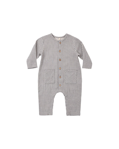 A black gingham jumpsuit featuring square patch pockets on the front and buttons down the center for easy changing.