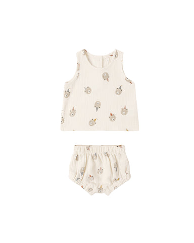 Baby outfit with sleeveless top and shorts on a white background