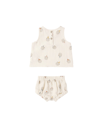 Children's cream-colored outfit with bear pattern on a white background