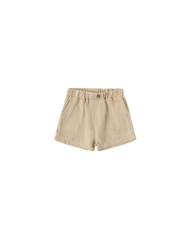 Butterscotch colored shorts on a white background