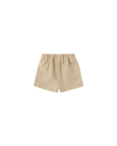Butterscotch colored shorts on a white background