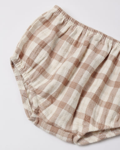 A close-up of a pair of cotton bloomers with a beige and cream gingham check pattern, featuring an elastic waistband.