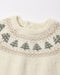 Close-up of a cream-colored knit sweater with a classic Fair Isle pattern featuring gray and tan Christmas trees and geometric borders around the crew neck.