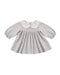 Baby dress with checkered pattern and white collar on a white background
