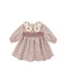 A baby girl's long-sleeve smocked dress in a brown and beige plaid pattern, featuring a cream-colored embroidered Peter Pan collar with brown floral details.