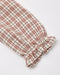 A close-up of a plaid fabric sleeve or cuff with gathered ruffles at one end, shown on a clean white background.