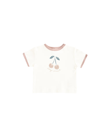 White t-shirt with pink trim and cherry design on a white background