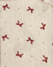 Close-up of a cream-colored knit fabric with a textured eyelet pattern and a repeating motif of small red embroidered bows.