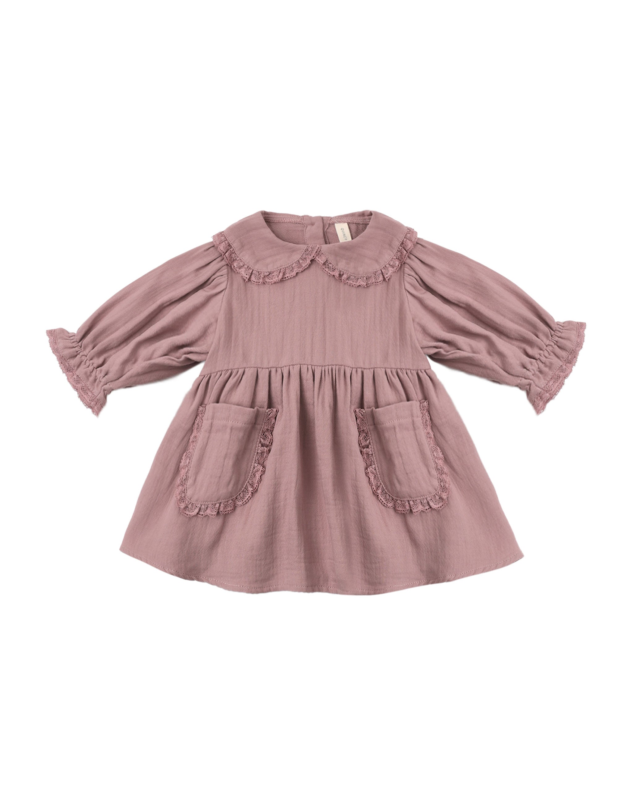 A dusty rose pink long-sleeve baby dress with a ruffled Peter Pan collar, gathered waist, and two front patch pockets with ruffle trim, shown on a plain white background.