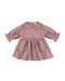 A dusty rose pink long-sleeve baby dress with a ruffled Peter Pan collar, gathered waist, and two front patch pockets with ruffle trim, shown on a plain white background.